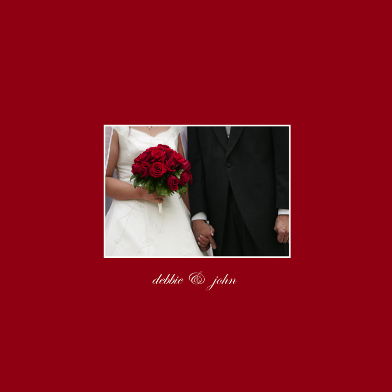 Cover of Debbie and John's wedding album: bride's red rose bouquet